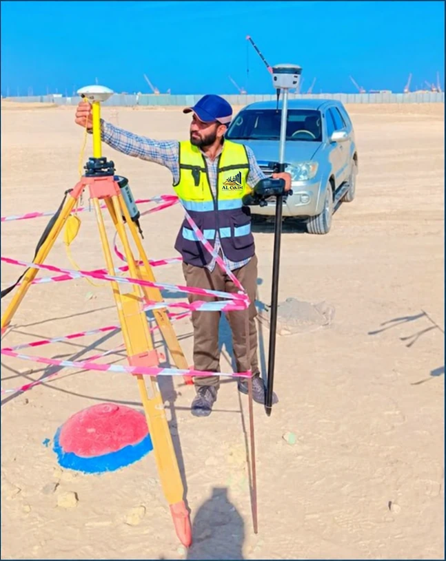 Surveyor with surveying equipment on an Oman construction site, from the company portfolio